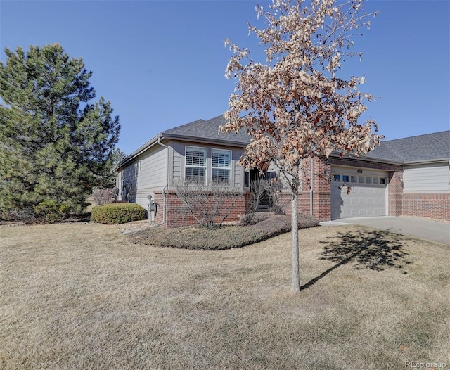 view of front of property with a front lawn, concrete driveway, brick siding, and an attached garage