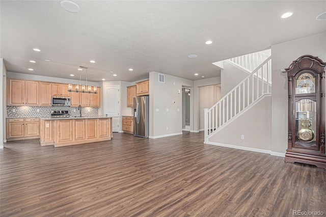 kitchen with recessed lighting, open floor plan, dark wood-style floors, and stainless steel appliances
