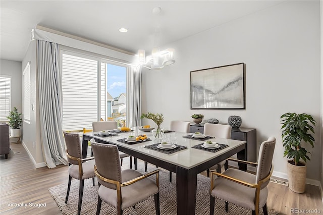 dining space with light wood-style floors, recessed lighting, and baseboards