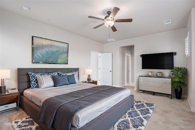 bedroom with light colored carpet, baseboards, visible vents, and ceiling fan