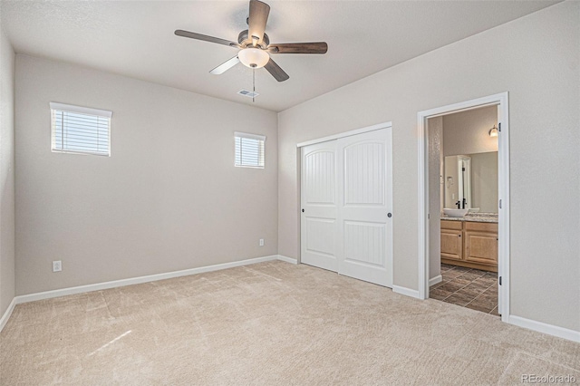 unfurnished bedroom featuring visible vents, carpet, a closet, and multiple windows