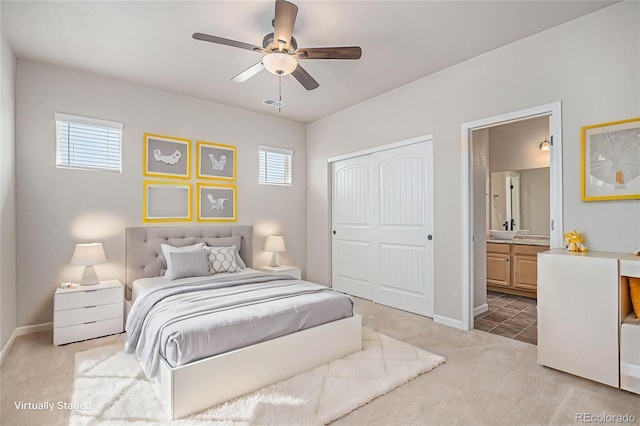 bedroom featuring visible vents, light carpet, multiple windows, and a closet