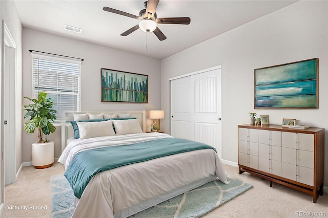 bedroom with baseboards, visible vents, carpet, and a closet