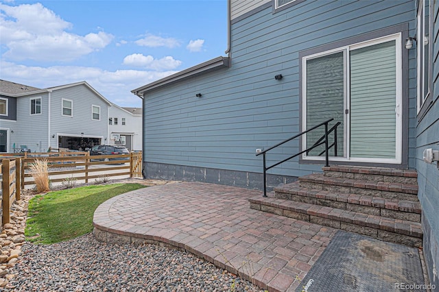 view of patio with fence and entry steps