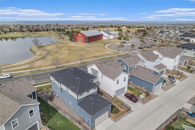 drone / aerial view featuring a residential view and a water view