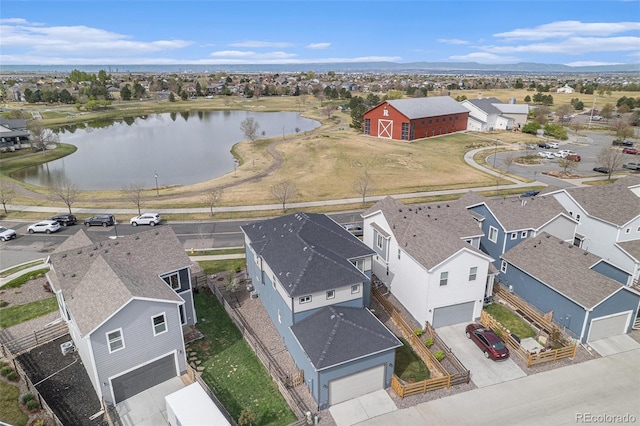birds eye view of property featuring a water view and a residential view