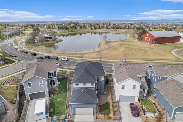 drone / aerial view featuring a water view and a residential view