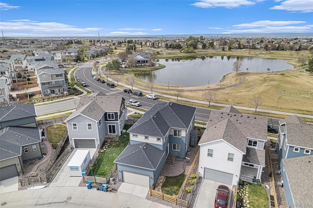 drone / aerial view featuring a residential view and a water view