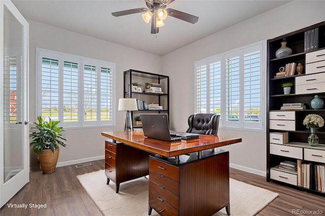 office featuring baseboards, dark wood finished floors, ceiling fan, and visible vents