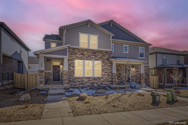 745 N Tempe St, Aurora, CO 80018 - view of front facade with fence and stone siding