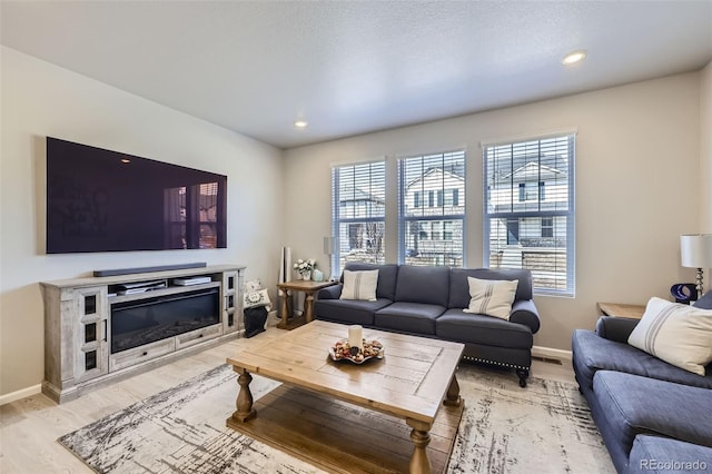 745 N Tempe St, Aurora, CO 80018 - living room with baseboards, light wood finished floors, and a wealth of natural light