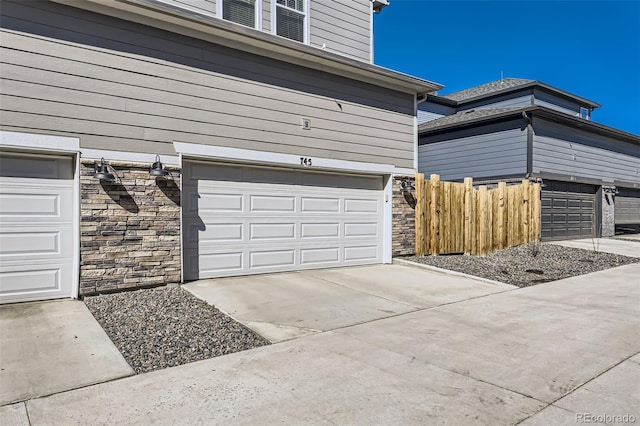 745 N Tempe St, Aurora, CO 80018 - garage featuring fence and concrete driveway
