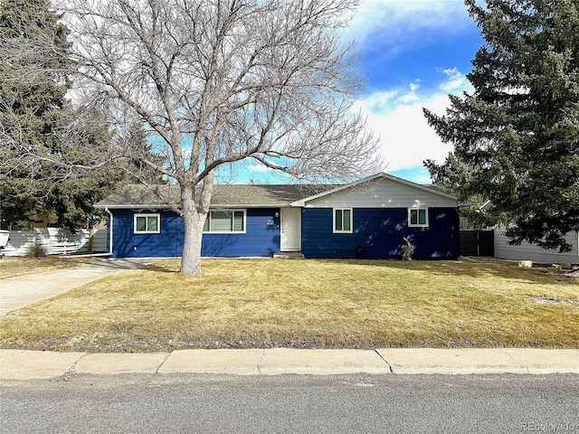 ranch-style house with concrete driveway, a front yard, and fence