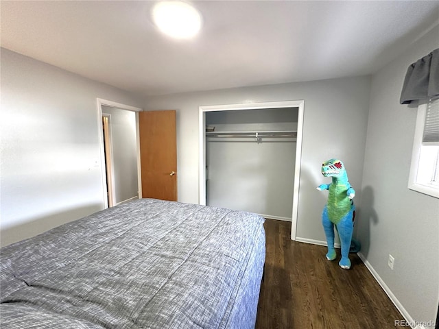 bedroom featuring a closet, baseboards, and wood finished floors