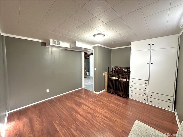 interior space featuring visible vents, baseboards, and wood finished floors