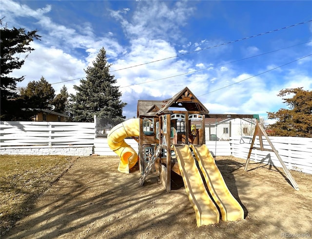 view of jungle gym featuring fence