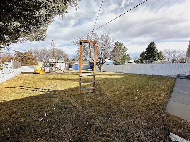 view of yard with a playground and fence