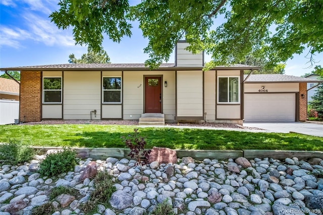 4064 S Olathe Ct, Aurora, CO 80013 - ranch-style house featuring an attached garage, concrete driveway, a front yard, and brick siding