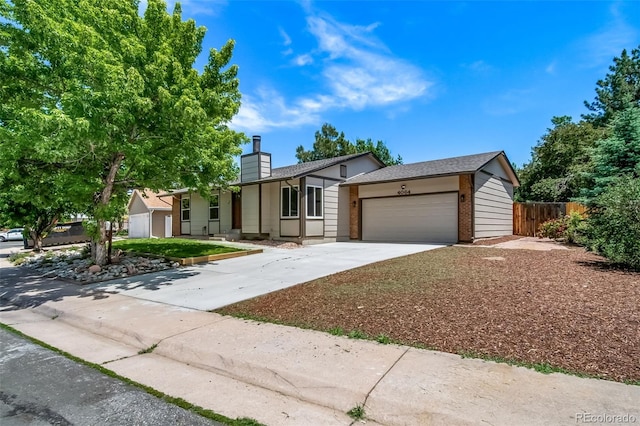 4064 S Olathe Ct, Aurora, CO 80013 - ranch-style house with a chimney, a garage, driveway, and brick siding