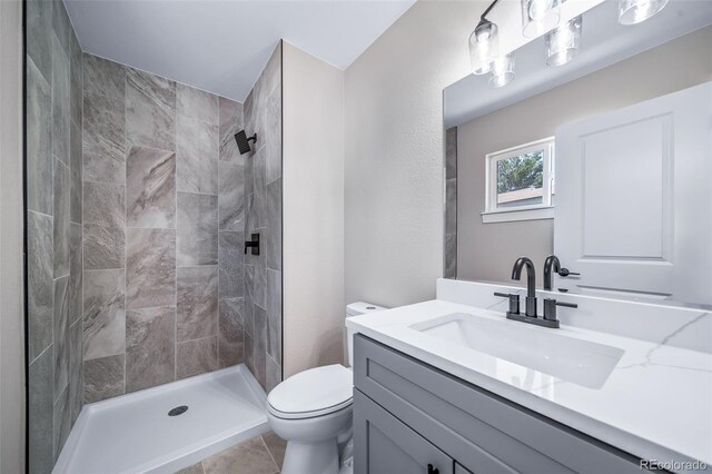 4064 S Olathe Ct, Aurora, CO 80013 - full bathroom featuring vanity, a tile shower, and tile patterned flooring