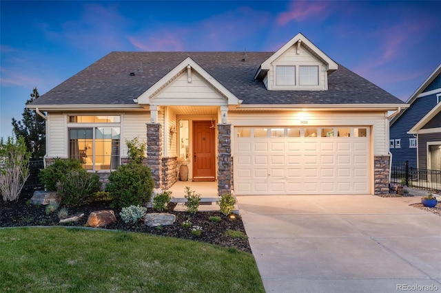 19688 E 52nd Ave, Denver, CO 80249 - craftsman inspired home featuring stone siding, concrete driveway, roof with shingles, and an attached garage
