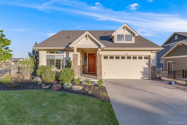 19688 E 52nd Ave, Denver, CO 80249 - craftsman house featuring stone siding, driveway, a garage, and roof with shingles