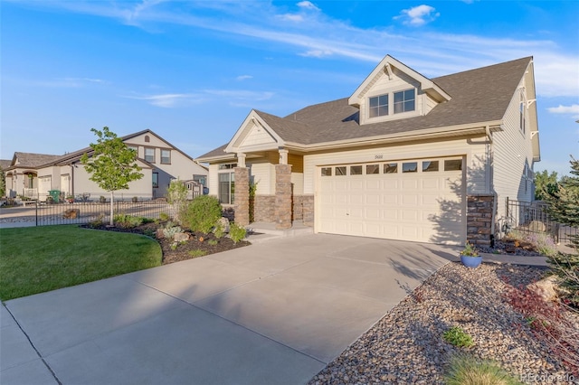 19688 E 52nd Ave, Denver, CO 80249 - view of front of home with stone siding, driveway, and a garage