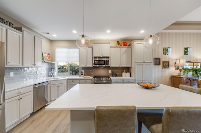 19688 E 52nd Ave, Denver, CO 80249 - kitchen with appliances with stainless steel finishes, a sink, decorative backsplash, a breakfast bar area, and recessed lighting