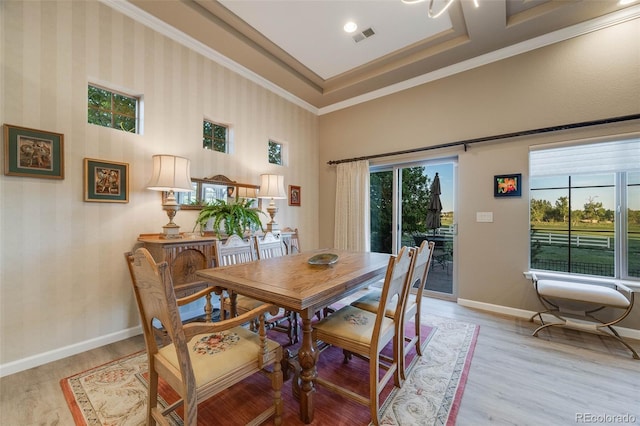 19688 E 52nd Ave, Denver, CO 80249 - dining space featuring baseboards, light wood finished floors, ornamental molding, and a high ceiling