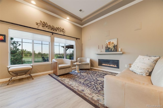 19688 E 52nd Ave, Denver, CO 80249 - living area featuring wood finished floors, ornamental molding, a glass covered fireplace, baseboards, and recessed lighting