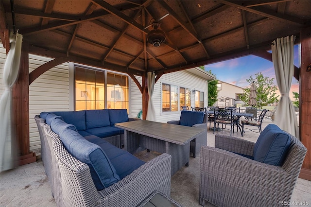 19688 E 52nd Ave, Denver, CO 80249 - patio terrace at dusk with an outdoor living space, a gazebo, and outdoor dining area