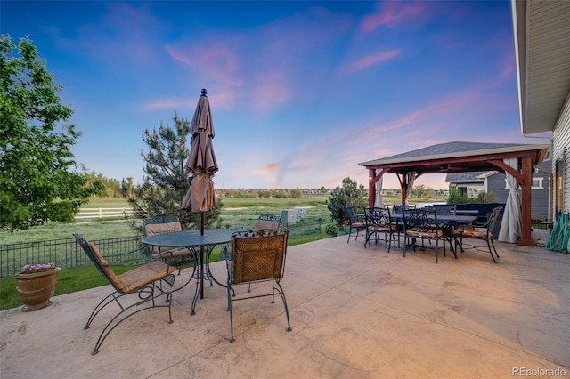 19688 E 52nd Ave, Denver, CO 80249 - view of patio / terrace with outdoor dining space, a gazebo, and fence