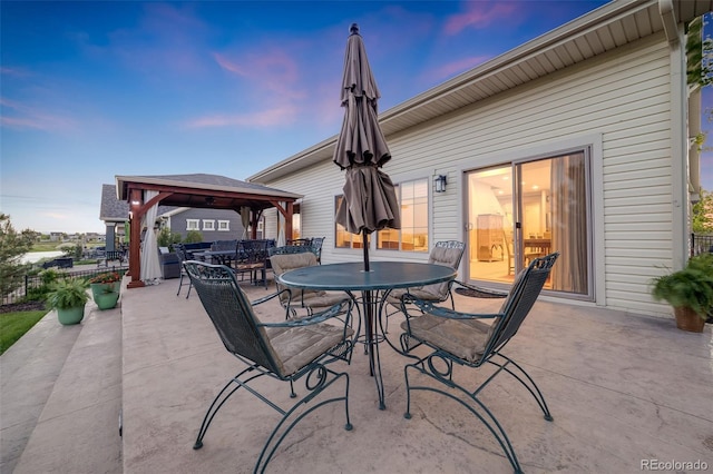 19688 E 52nd Ave, Denver, CO 80249 - patio terrace at dusk with a gazebo and outdoor dining space