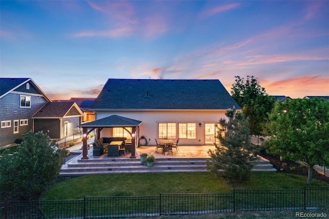 19688 E 52nd Ave, Denver, CO 80249 - back of house at dusk featuring an outdoor hangout area and a gazebo