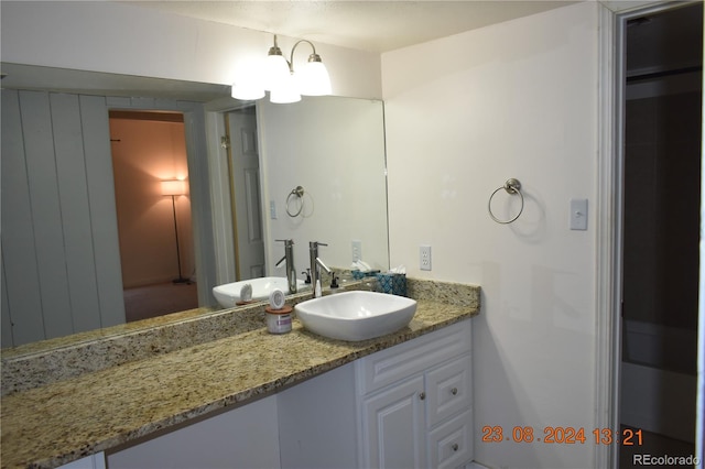 bathroom with vanity and an inviting chandelier