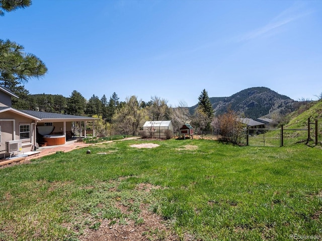2571 SW Grapevine Rd, Idledale, CO 80453 - view of yard with a hot tub, a mountain view, and an outdoor structure
