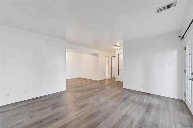 empty room with light hardwood / wood-style flooring