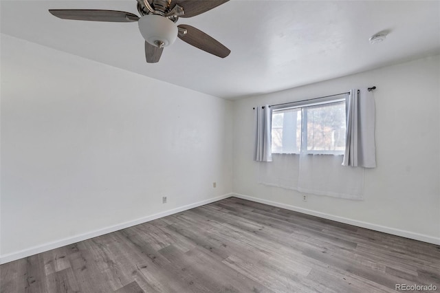 spare room with light wood-type flooring and ceiling fan