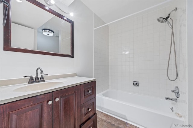 bathroom with vanity and tiled shower / bath