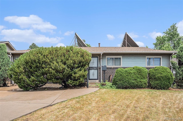 9590 Lowell Blvd, Westminster, CO 80031 - view of front facade featuring a front yard and brick siding
