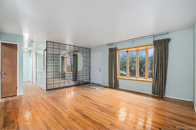9590 Lowell Blvd, Westminster, CO 80031 - unfurnished living room with hardwood / wood-style floors and baseboards