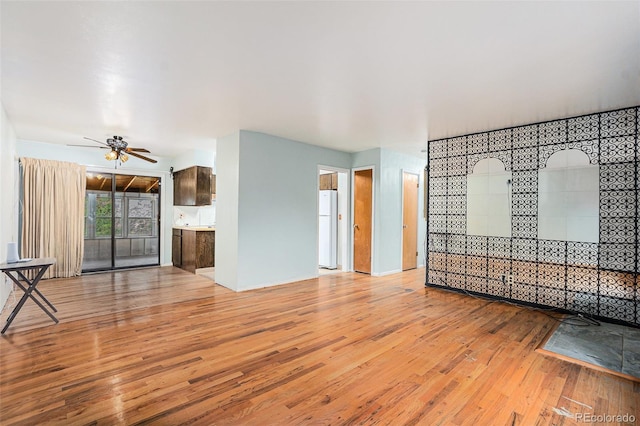 9590 Lowell Blvd, Westminster, CO 80031 - unfurnished living room featuring light wood-style flooring and ceiling fan