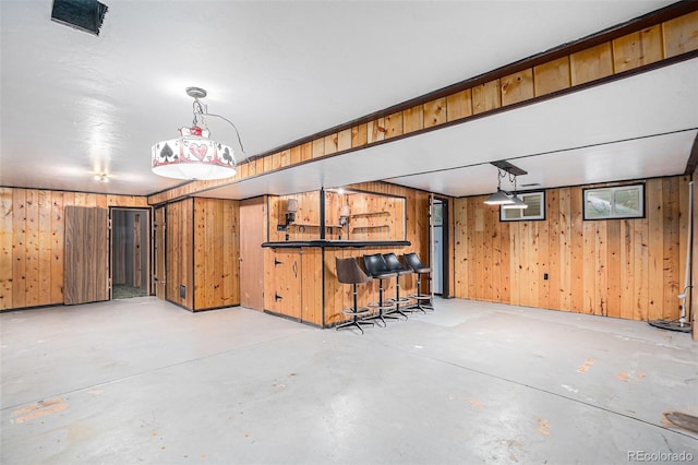9590 Lowell Blvd, Westminster, CO 80031 - indoor dry bar featuring concrete floors, wooden walls, and hanging light fixtures