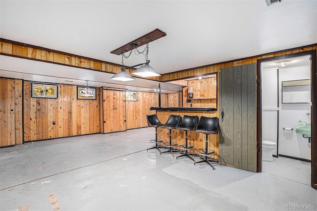 9590 Lowell Blvd, Westminster, CO 80031 - kitchen featuring wood walls and concrete flooring