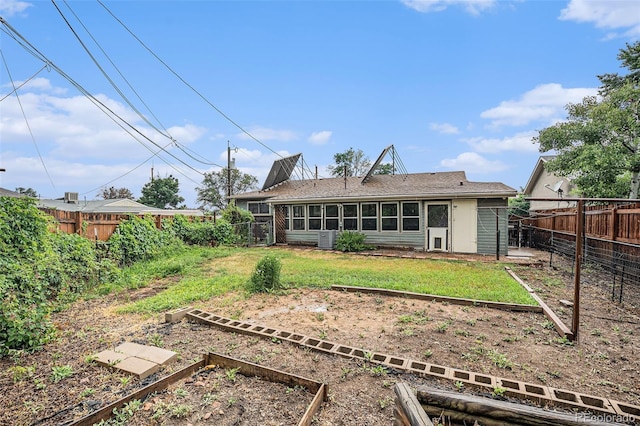 9590 Lowell Blvd, Westminster, CO 80031 - rear view of property with a vegetable garden and a fenced backyard