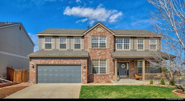 view of front of property with a front yard and a garage