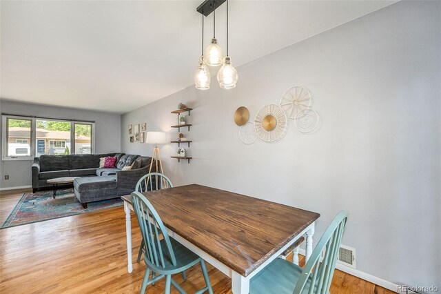 dining room featuring light wood-style floors and baseboards