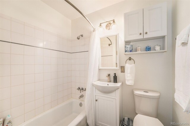 full bath featuring toilet, shower / bathtub combination with curtain, and vanity