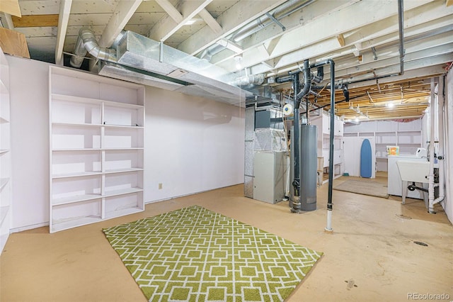 unfinished basement featuring heating unit, a sink, washer / clothes dryer, and gas water heater