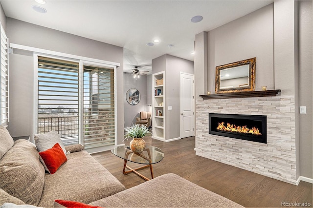 24943 E Phillips Pl, Aurora, CO 80016 - living room featuring a stone fireplace, a ceiling fan, wood finished floors, baseboards, and recessed lighting